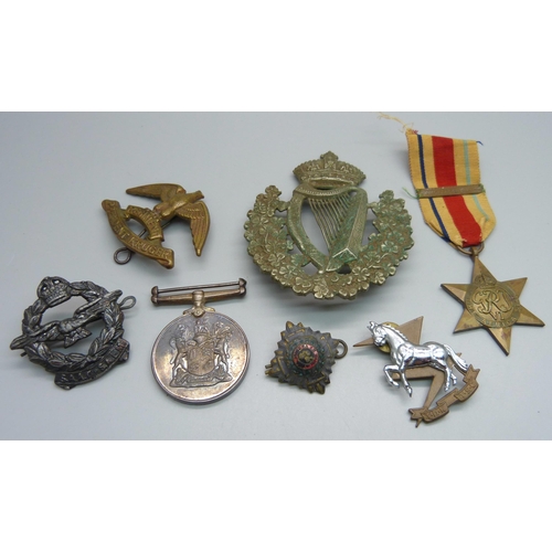 885 - A Regiment President Kruger military badge, a large Irish regimental badge, a South Africa For War S... 