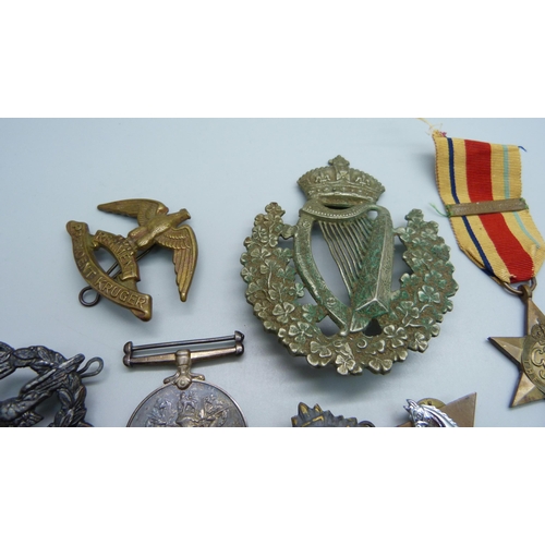 885 - A Regiment President Kruger military badge, a large Irish regimental badge, a South Africa For War S... 