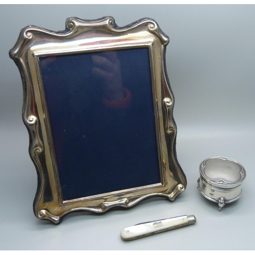 901 - A silver photograph frame, 14cm x 18cm, a silver ring box and a silver and mother of pearl penknife