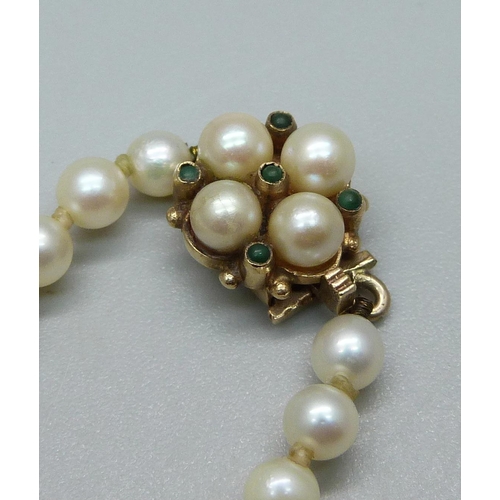 938 - A string of cultured pearls with a 9ct gold clasp set with pearls and turquoise, 58cm