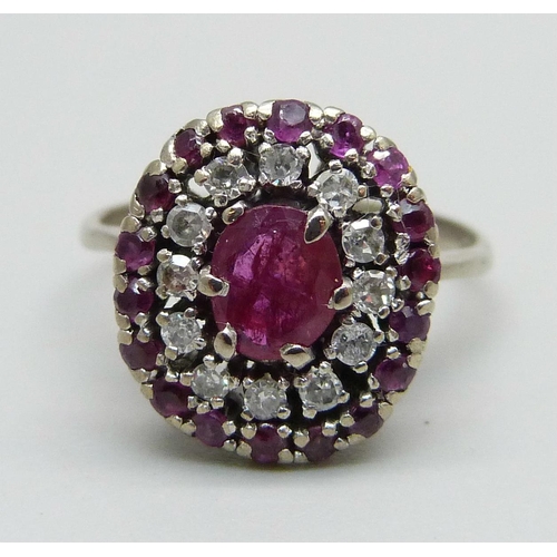 976 - A white metal, ruby and diamond cluster ring, marked 950, 4.6g, O