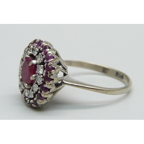 976 - A white metal, ruby and diamond cluster ring, marked 950, 4.6g, O