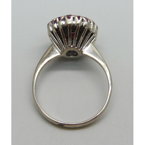 976 - A white metal, ruby and diamond cluster ring, marked 950, 4.6g, O