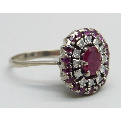 976 - A white metal, ruby and diamond cluster ring, marked 950, 4.6g, O