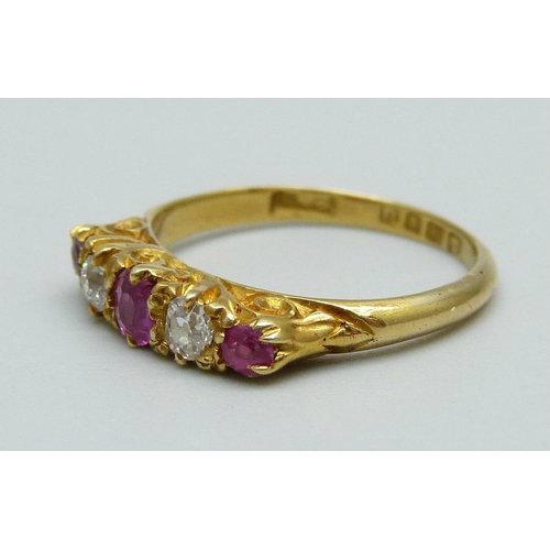 977 - An 18ct gold, ruby and diamond ring, 2.5g, K, one red stone possibly a replacement