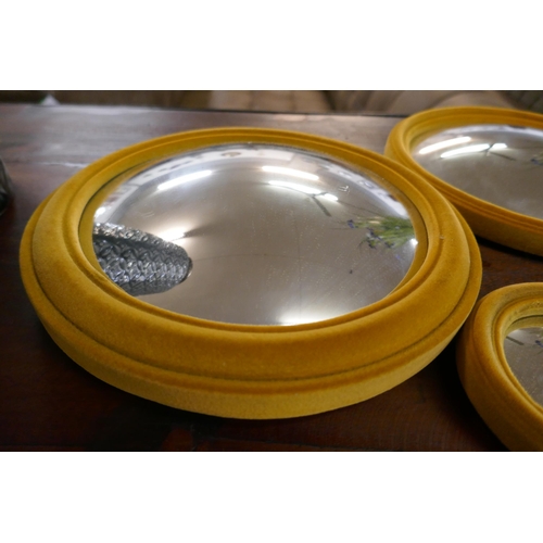 1305 - A set of seven mustard convex mirrors