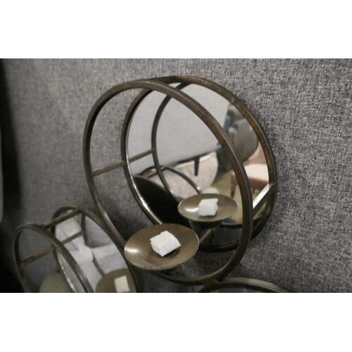 1409 - An industrial mirrored candle holder