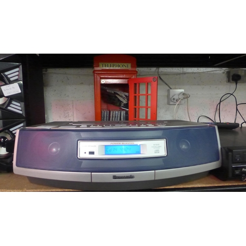 2140 - A Power Blaster Sound Virtualiser (model RX-ED50) with a collection of CDs in a phone booth style ca... 