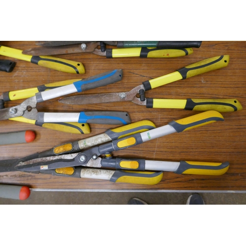 2306 - A large quantity of garden tools including various brands of hedge shears, a bow saw and long reach ... 