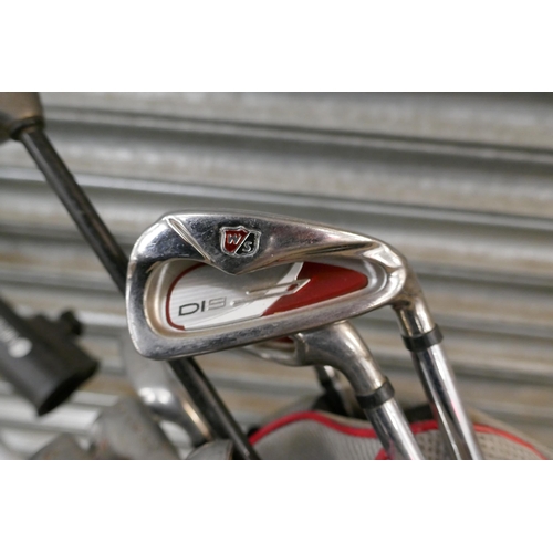 2308 - A Motocaddy digital S1 golf trolley and bag with a set of clubs including- Wilson staff DI9 P,S,4,5,... 