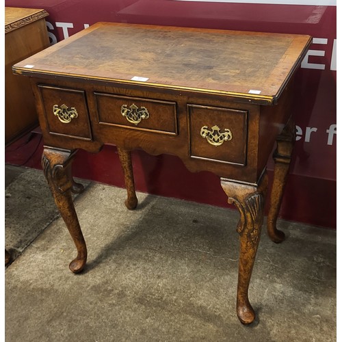 113 - A Queen Anne style burr walnut lowboy