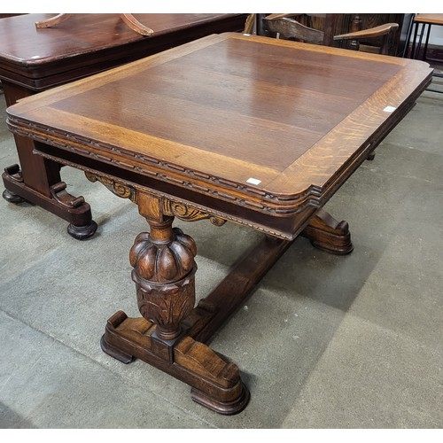 145 - A carved oak draw-leaf table