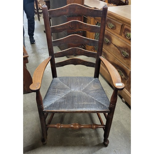 147 - A 19th Century elm rush seated elm ladderback elbow chair