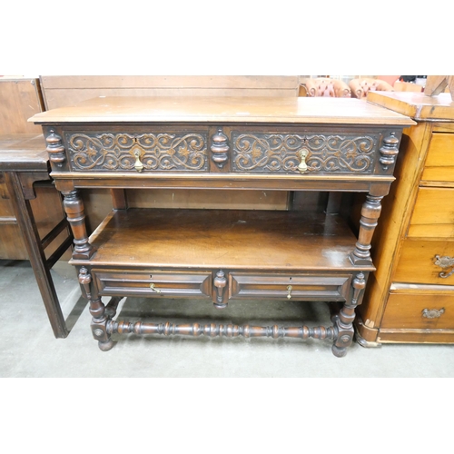 106 - A late Victorian Elizabethan Revival carved walnut two drawer buffet