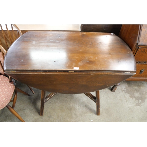 109 - An Ercol Golden Dawn elm and beech Windsor drop leaf table and four chairs