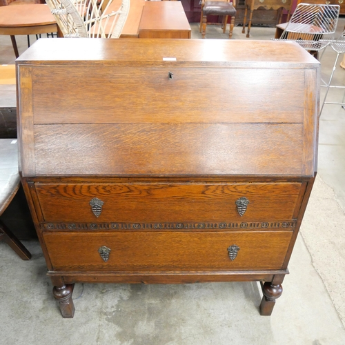 110 - An early 20th Century carved oak bureau