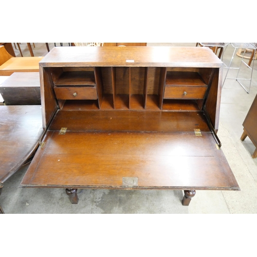 110 - An early 20th Century carved oak bureau