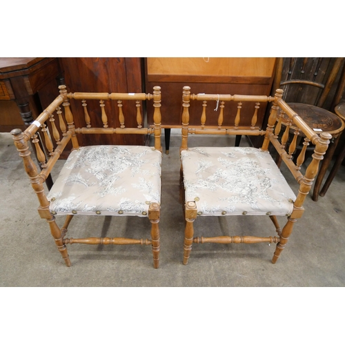 115 - A pair of Victorian walnut bobbin turned corner chairs