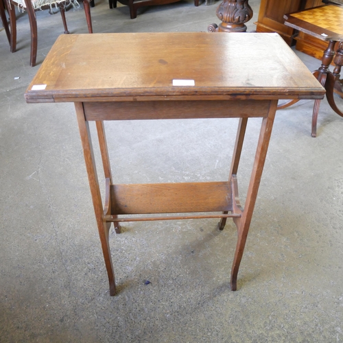 122 - An Arts and Crafts oak fold over games table