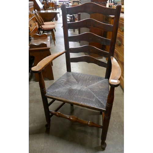 147 - A 19th Century elm rush seated elm ladderback elbow chair