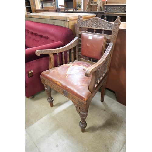 152 - A Victorian Aesthetic Movement carved oak elbow chair