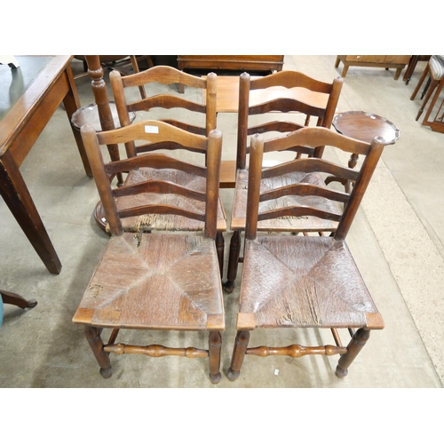 156 - A set of four 19th Century rush seated elm ladderback chairs