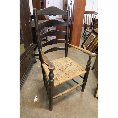 184 - A 19th Century rush seated elm elbow chair