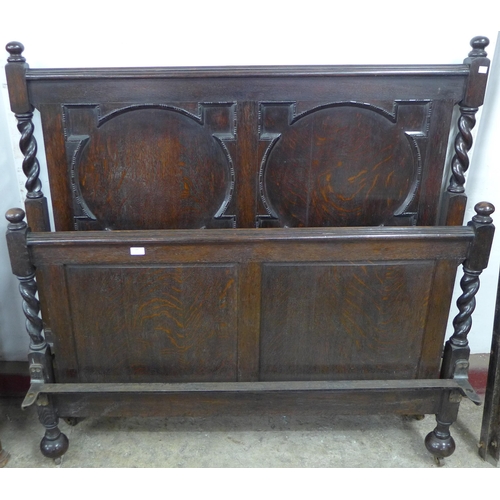 199 - An early 20th Century oak geometric moulded double bed