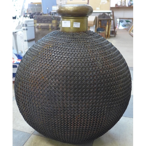 202 - A large eastern chain wrapped brass bottle shaped vessel