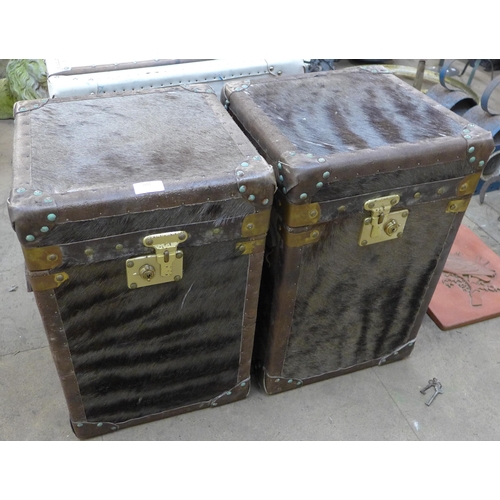 203 - A pair of hide covered and brass mounted trunks