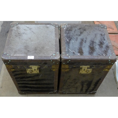 203 - A pair of hide covered and brass mounted trunks