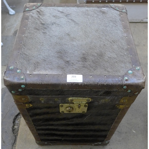 203 - A pair of hide covered and brass mounted trunks