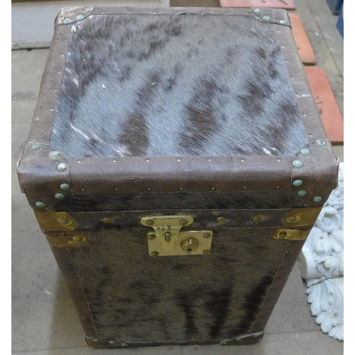 203 - A pair of hide covered and brass mounted trunks