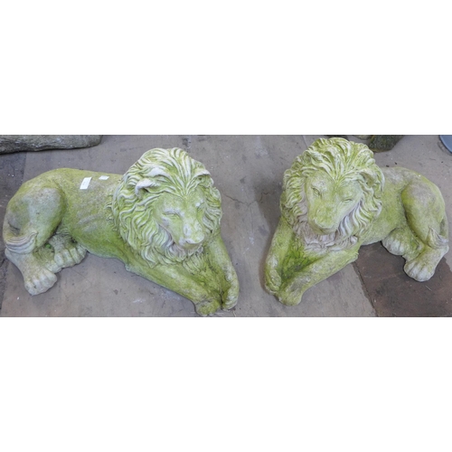 212 - A pair of concrete garden figures of recumbent lions