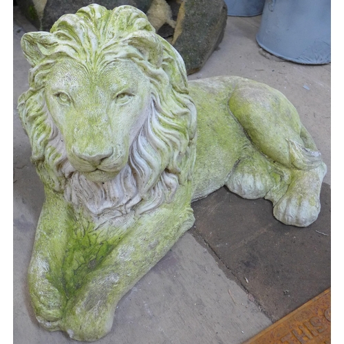 212 - A pair of concrete garden figures of recumbent lions