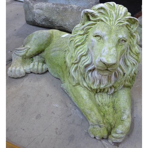 212 - A pair of concrete garden figures of recumbent lions