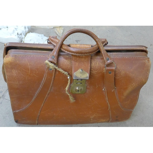 218 - An Islamic brass topped occasional table, a copper and brass coal bucket and a leather Gladstone bag