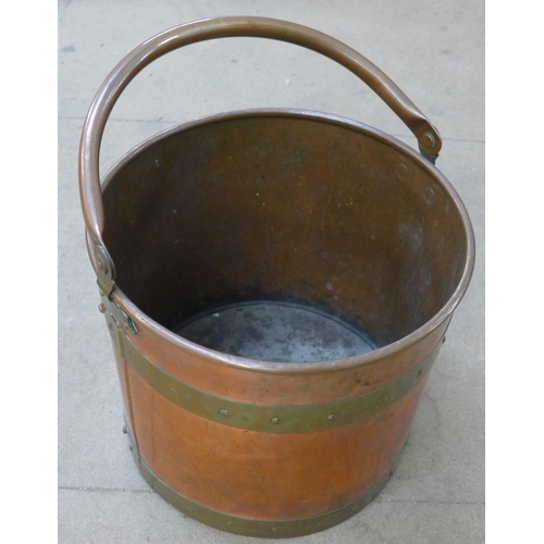 218 - An Islamic brass topped occasional table, a copper and brass coal bucket and a leather Gladstone bag