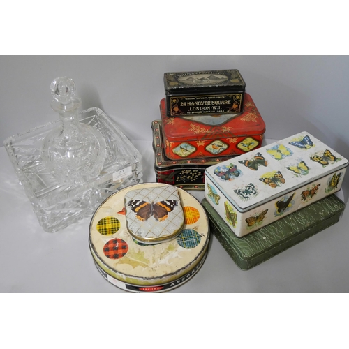 253 - A glass decanter and fruit bowl and seven vintage tins