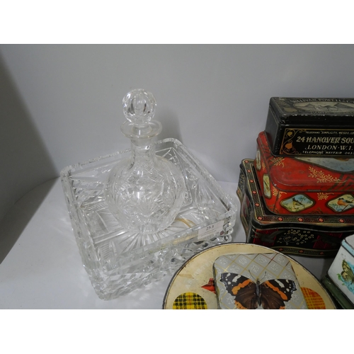 253 - A glass decanter and fruit bowl and seven vintage tins