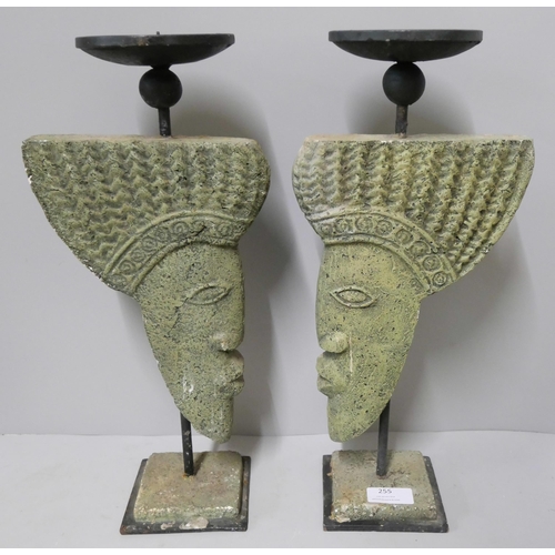 255 - A pair of African faux stone candlesticks