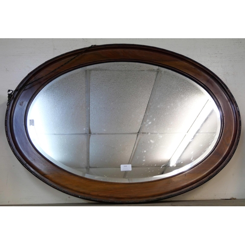 269 - An Edward VII oak framed oval mirror