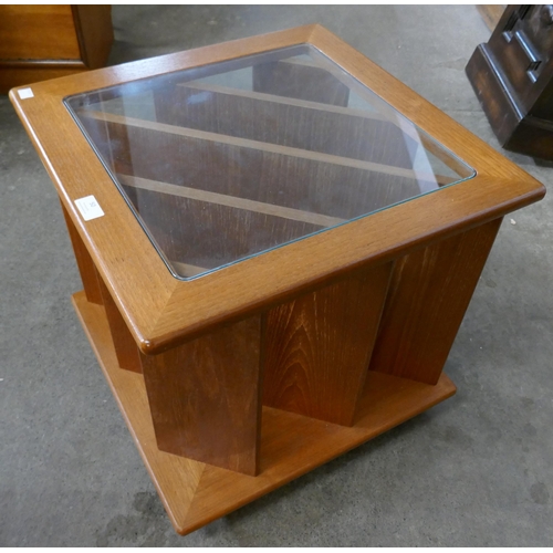 40 - A teak and glass topped coffee table/magazine rack