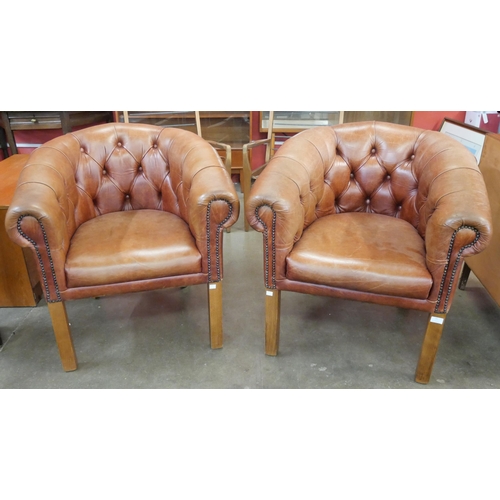 79 - A pair of brown leather Chesterfield club chairs