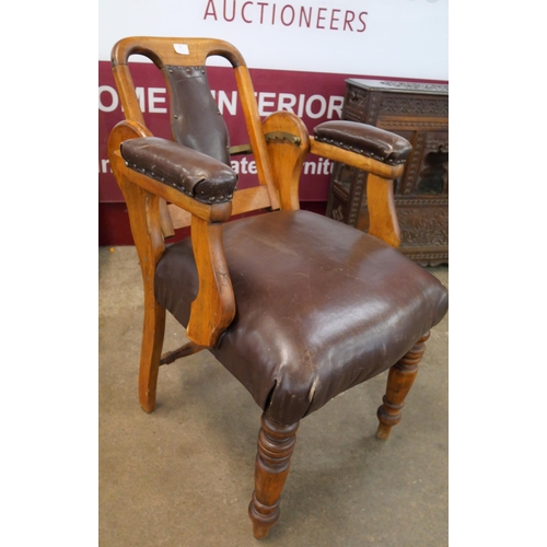 82 - An early 20th Century beech and brown leather adjustable dentist's chair