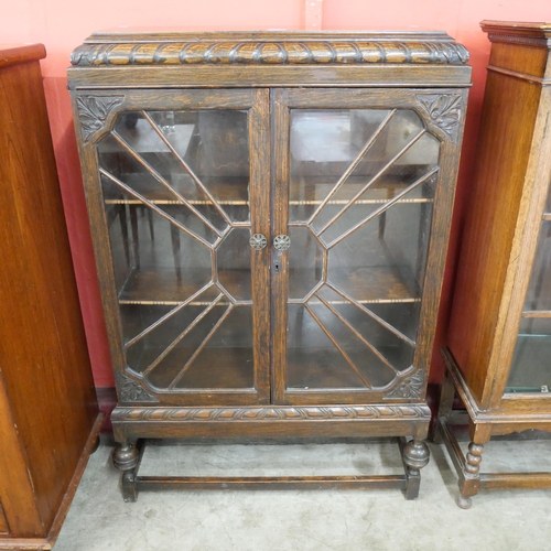 85 - An early 20th Century carved oak two door bookcase