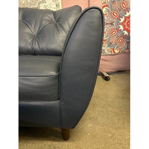 1551 - A Hoxton dark blue leather armchair and footstool