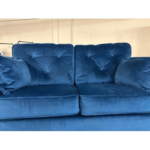 1560 - A Hoxton blue velvet upholstered two seater sofa, RRP £779