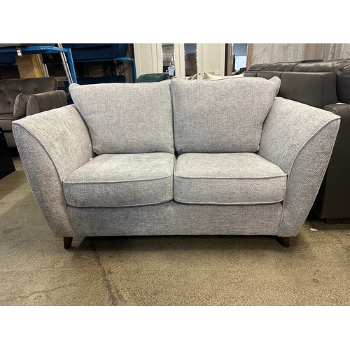 1573 - A grey textured weave upholstered two seater sofa