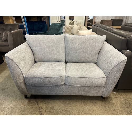 1573 - A grey textured weave upholstered two seater sofa